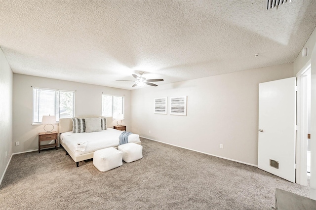 bedroom with ceiling fan, carpet, and a textured ceiling