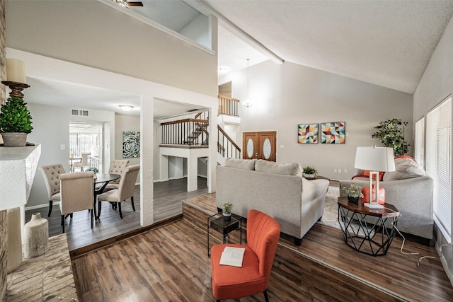 living room featuring beamed ceiling, dark hardwood / wood-style flooring, and high vaulted ceiling