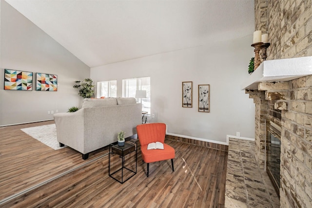 living room with a fireplace, high vaulted ceiling, and hardwood / wood-style flooring