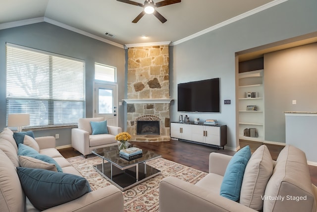 living room with ceiling fan, crown molding, wood-type flooring, lofted ceiling, and a fireplace