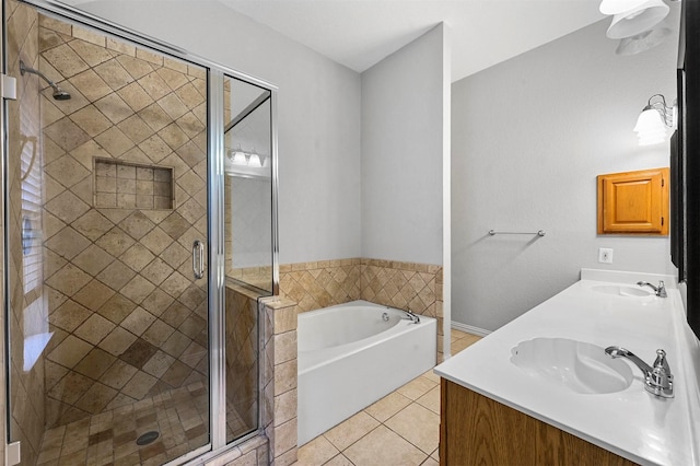 bathroom featuring tile patterned floors, vanity, and shower with separate bathtub