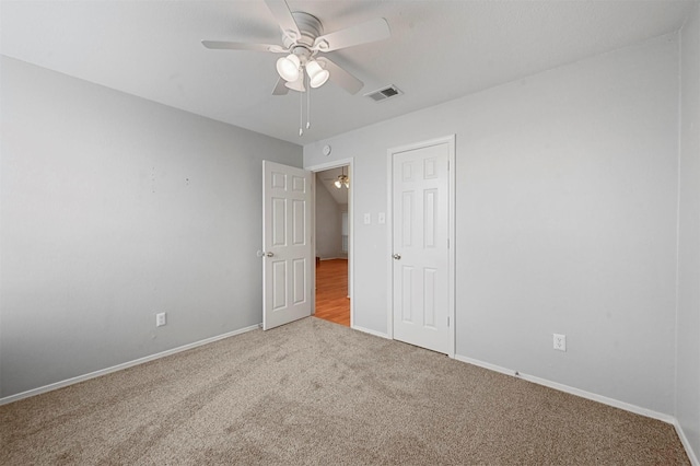 unfurnished bedroom featuring ceiling fan and carpet floors