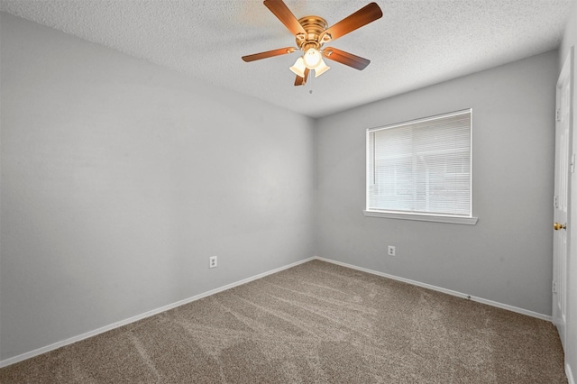 carpeted empty room with ceiling fan and a textured ceiling