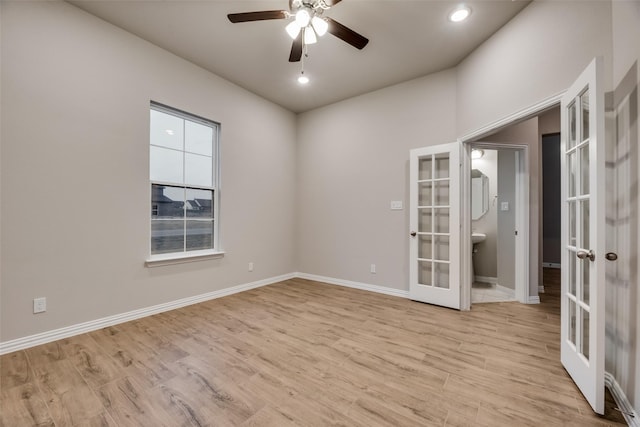 unfurnished room featuring ceiling fan, light hardwood / wood-style flooring, and french doors