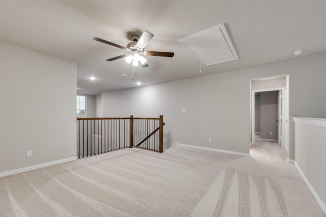 carpeted spare room featuring ceiling fan