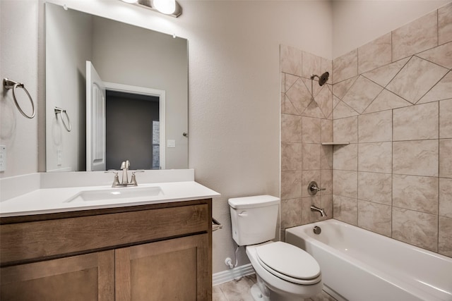 full bathroom with vanity, tiled shower / bath combo, hardwood / wood-style flooring, and toilet