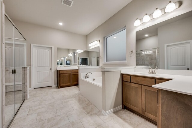 bathroom with vanity and separate shower and tub