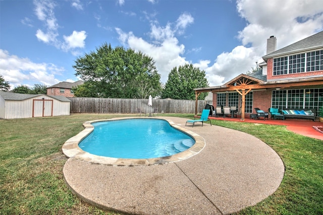 view of pool featuring a lawn, an outdoor living space, a patio area, and a shed