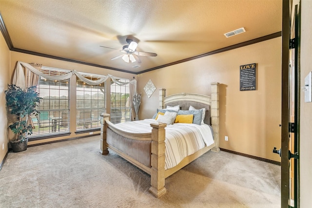 bedroom featuring ceiling fan, crown molding, carpet floors, and a textured ceiling