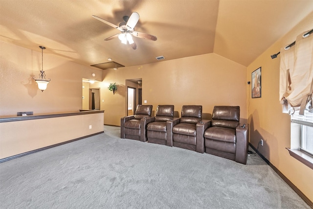 carpeted cinema with ceiling fan and lofted ceiling