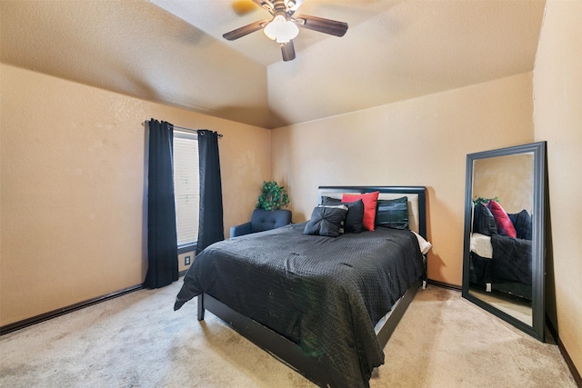 carpeted bedroom with ceiling fan and vaulted ceiling