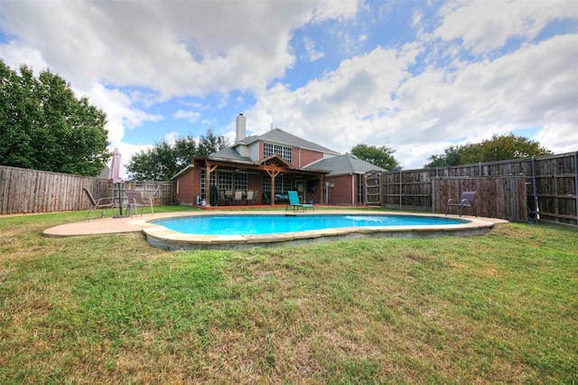 view of pool with a lawn and a patio area