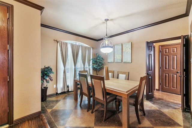 dining space featuring an inviting chandelier and crown molding