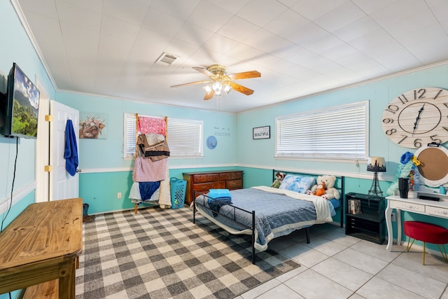 bedroom featuring ceiling fan, light tile patterned floors, and crown molding