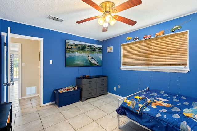 tiled bedroom with ceiling fan, ornamental molding, and a textured ceiling