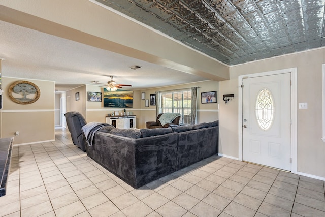 tiled living room with ceiling fan