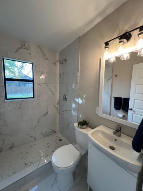 232 Alto Dr, Garland, TX 75040 - bathroom with toilet, marble finish floor, a marble finish shower, and vanity
