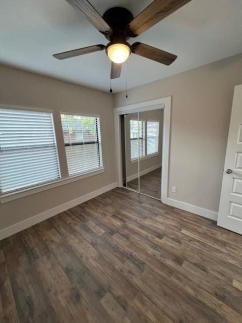 232 Alto Dr, Garland, TX 75040 - unfurnished bedroom with ceiling fan, a closet, baseboards, and dark wood-style flooring