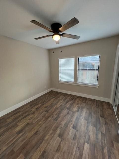 unfurnished room featuring dark hardwood / wood-style floors and ceiling fan