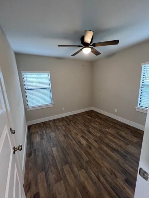 unfurnished room featuring ceiling fan and dark wood-type flooring