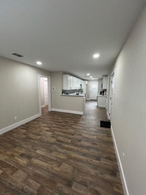 232 Alto Dr, Garland, TX 75040 - unfurnished living room featuring baseboards, dark wood finished floors, visible vents, and recessed lighting