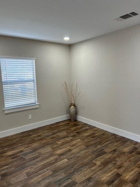 empty room with dark wood-type flooring