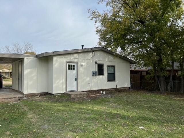 rear view of house with a yard and a carport