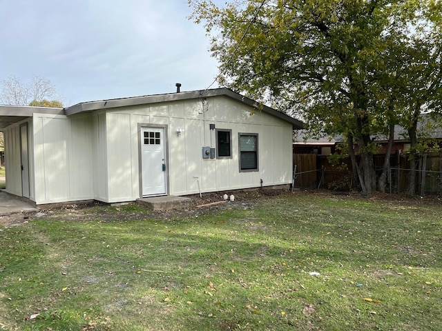 back of house with a lawn