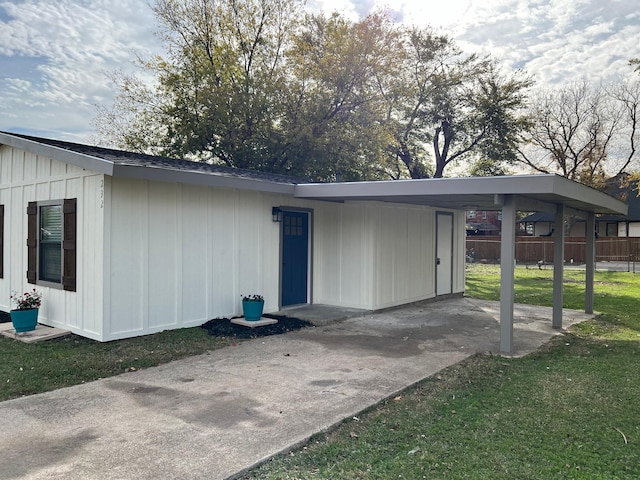 exterior space with a lawn and a carport