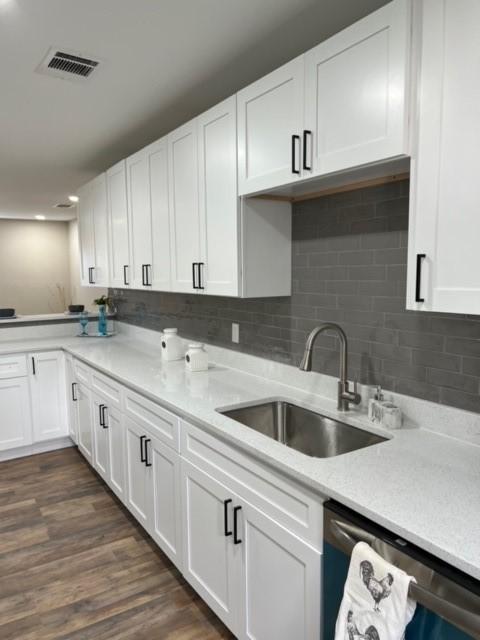 232 Alto Dr, Garland, TX 75040 - kitchen with dark wood-style flooring, visible vents, white cabinets, a sink, and dishwasher
