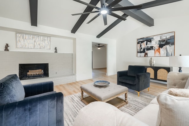 living room with a fireplace, hardwood / wood-style floors, lofted ceiling with beams, and ceiling fan