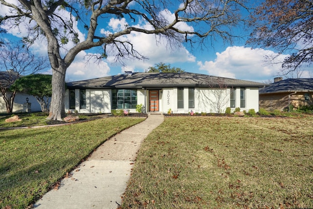 ranch-style home with a front lawn