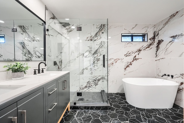 bathroom featuring vanity, tile walls, and independent shower and bath