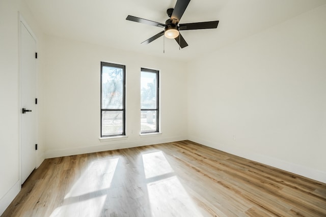 spare room featuring light hardwood / wood-style floors, plenty of natural light, and ceiling fan