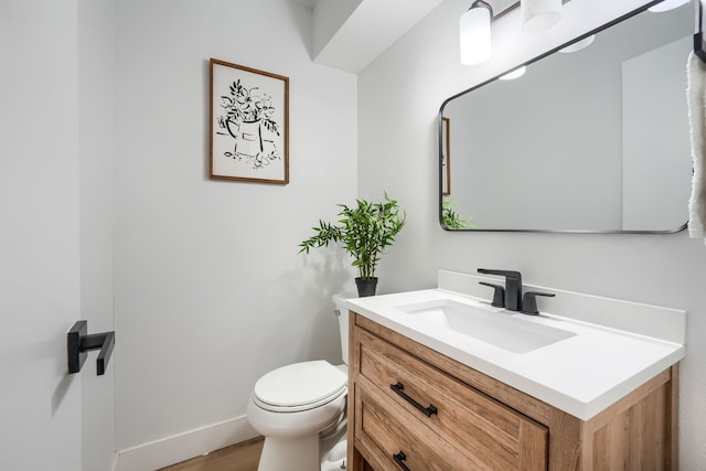 bathroom featuring vanity, toilet, and wood-type flooring