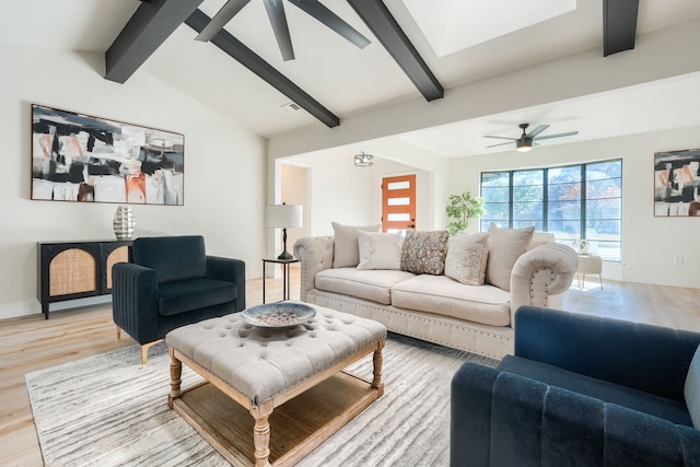 living room with vaulted ceiling with beams, light hardwood / wood-style floors, and ceiling fan