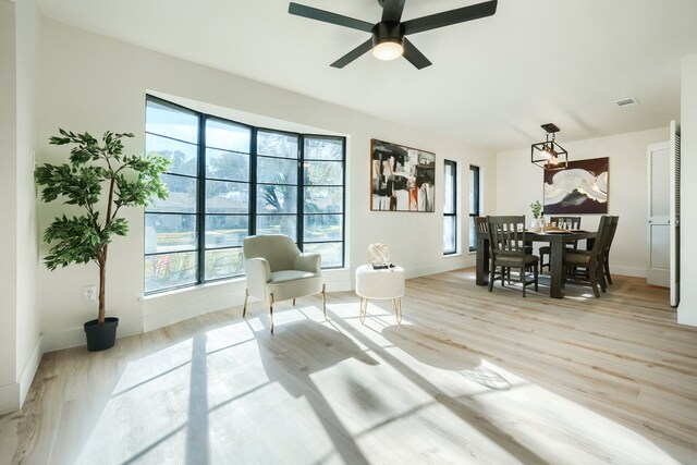 sitting room with ceiling fan and light hardwood / wood-style floors