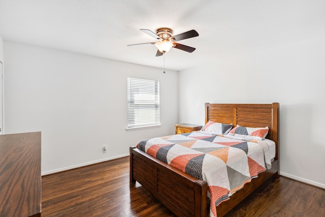 bedroom with dark hardwood / wood-style flooring and ceiling fan