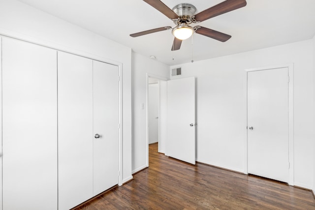 unfurnished bedroom featuring ceiling fan and dark hardwood / wood-style flooring