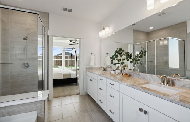 bathroom featuring tile patterned floors, vanity, and a shower with door