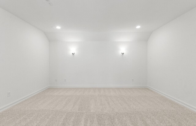 carpeted bedroom featuring a chandelier and vaulted ceiling