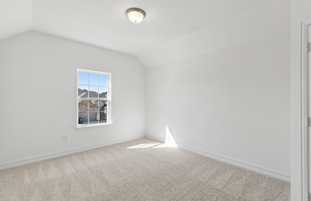 carpeted bedroom with lofted ceiling and a notable chandelier