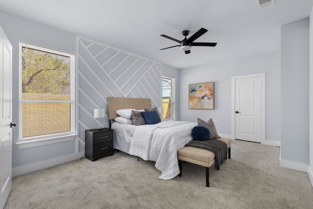 bedroom with ceiling fan and light carpet