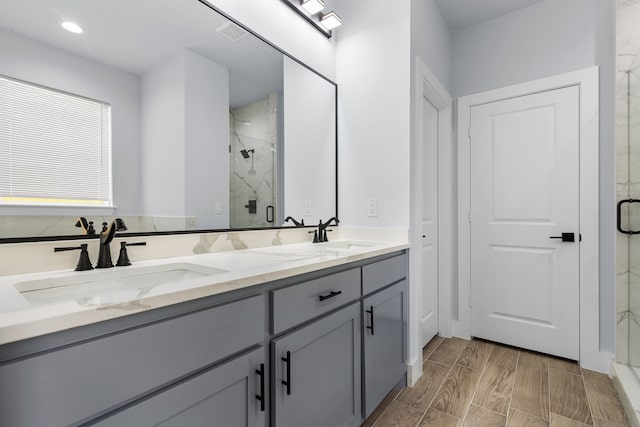 bathroom featuring vanity and a shower with shower door