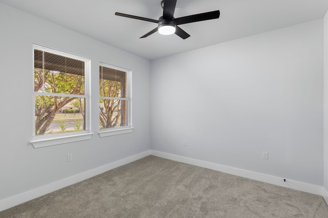 empty room with ceiling fan and light colored carpet