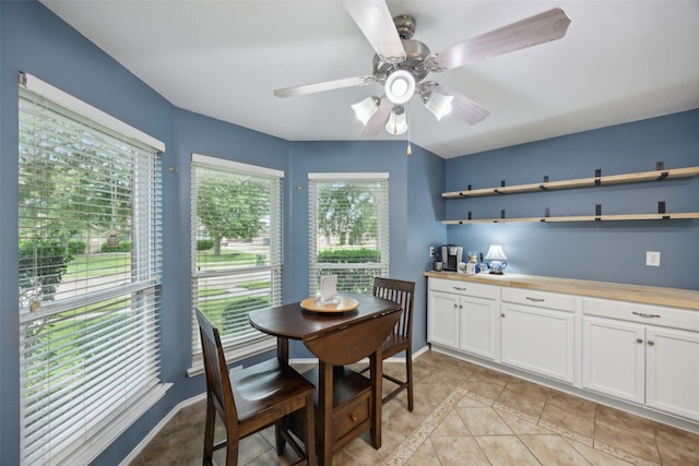 dining room with ceiling fan and light tile patterned flooring