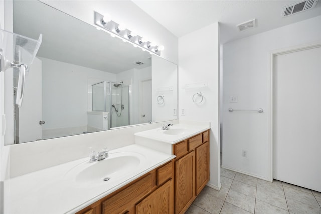 bathroom with tile patterned flooring, vanity, and an enclosed shower