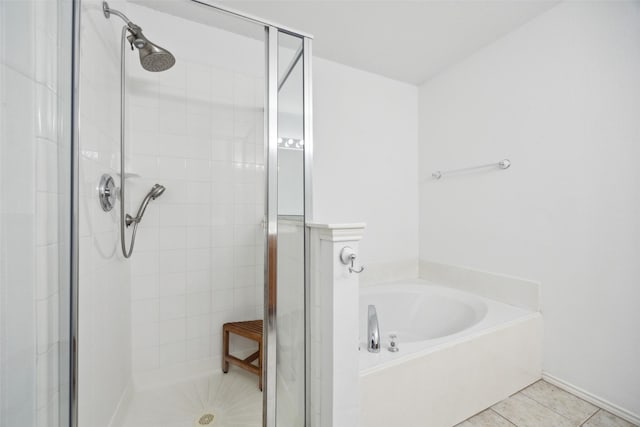 bathroom featuring tile patterned floors and shower with separate bathtub