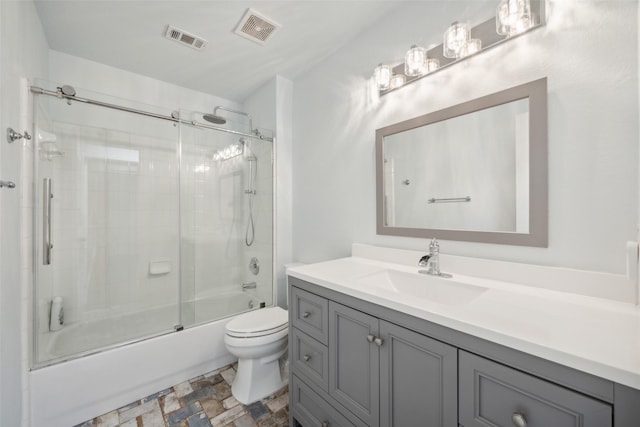 full bathroom with toilet, combined bath / shower with glass door, and vanity