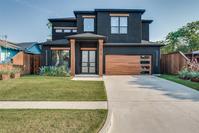 view of front of property with a front lawn and a garage